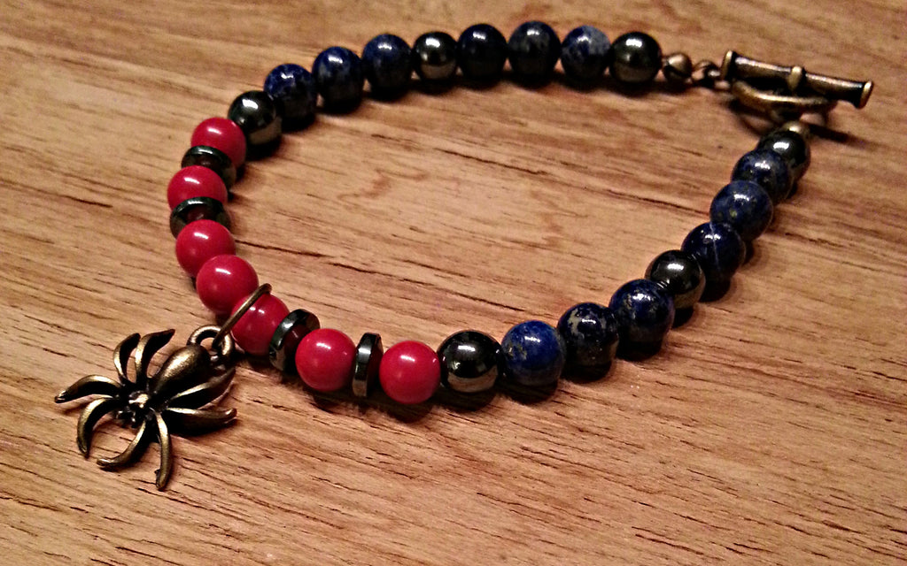 Antique brass spider charm with 6mm red coral, blue lapis lazuli and hematite beads and discs; beaded bracelet by Muse