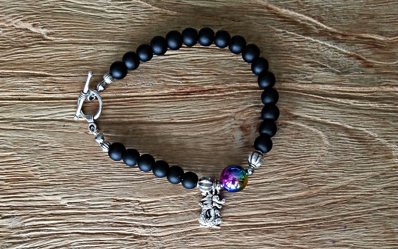 6mm obsidian with silver dragon charm and 12mm psychedelic plastic bead
