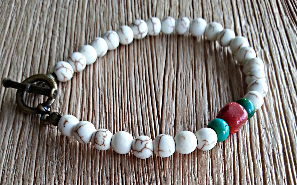 6mm cream howlite beads are paired with turquoise rondelles and a single cuboid cinnabar bead in this beaded bracelet for men and women