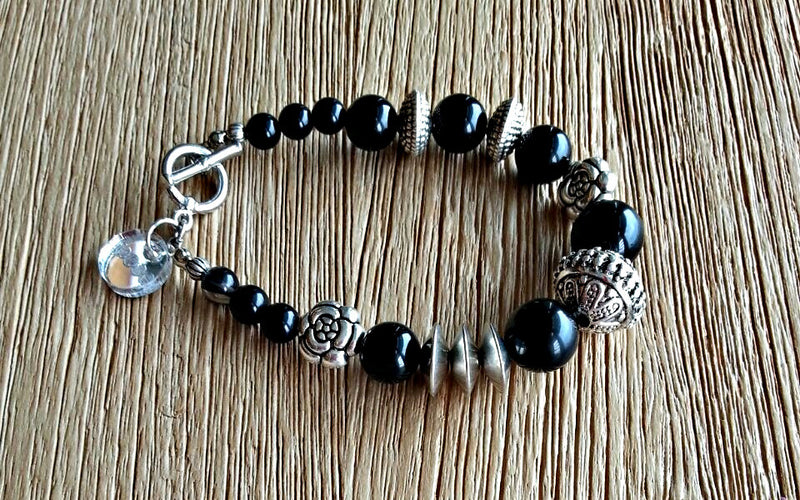 Onyx and silver beads in varying sizes from 6-14mm make up this beaded bracelet for the ladies.