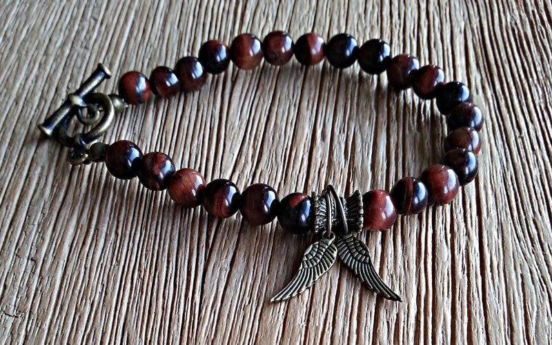 Antique brass wings with 6mm red tiger eye beads. Beaded bracelets for men and women.